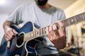 Young man practicing acoustic guitar at home.Focus selective Royalty Free Stock Photo