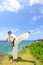 Young man practicing karate at beach