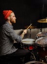 Young man practicing play on drums before concert Royalty Free Stock Photo