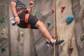 Young man practicing rock climbing on artificial wall indoors. Royalty Free Stock Photo