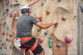 Young man practicing rock climbing on artificial wall indoors. Royalty Free Stock Photo