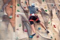 Young man practicing rock climbing on artificial wall indoors. Royalty Free Stock Photo