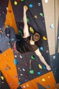 Young man practicing rock-climbing in climbing gym Royalty Free Stock Photo