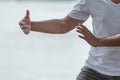 Young man practicing traditional Tai Chi Chuan, Tai Ji and Qi gong in the park for healthy, traditional chinese martial arts