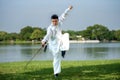 Young man practicing traditional Tai Chi Sword, Tai Ji in the park for healthy, traditional chinese martial arts concept Royalty Free Stock Photo