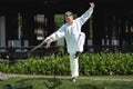 Young man practicing traditional Tai Chi Sword, Tai Ji in the park for healthy, traditional chinese martial arts concept Royalty Free Stock Photo