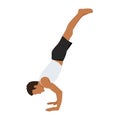 Young man practicing yoga handstand exercise