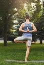 Young man practicing yoga, Reverse Prayer Pose