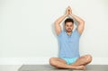 Young man practicing zen yoga near wall Royalty Free Stock Photo