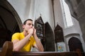 Young man praying in a church Royalty Free Stock Photo