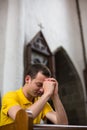 Young man praying in a church Royalty Free Stock Photo