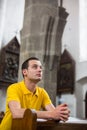 Young man praying in a church Royalty Free Stock Photo