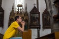 Young man praying in a church Royalty Free Stock Photo