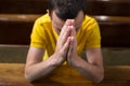 Young man praying in a church Royalty Free Stock Photo