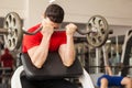 Young man in a preacher bench at the gym Royalty Free Stock Photo