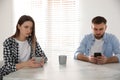 Man preferring smartphone over his girlfriend at home. Relationship problems