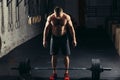 Handsome weightlifter preparing for training with barbell Royalty Free Stock Photo