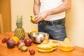 Young man preparing a fruit salad or smoothie Royalty Free Stock Photo