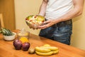 Young man preparing a fruit salad or smoothie Royalty Free Stock Photo