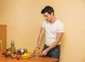 Young man preparing a fruit salad or smoothie Royalty Free Stock Photo