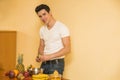 Young man preparing a fruit salad or smoothie Royalty Free Stock Photo