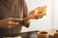 Young man preparing a healthy breakfast spreading strawberry jam on slice of bread Royalty Free Stock Photo