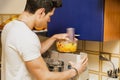 Young man preparing healthy fruit smoothie Royalty Free Stock Photo