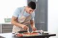 Young man preparing tasty pizza at table Royalty Free Stock Photo