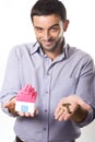 Young Man presenting Miniature House and Key Royalty Free Stock Photo