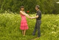 Young man presents red rose to young woman Royalty Free Stock Photo