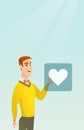 Young man pressing heart shaped button. Royalty Free Stock Photo