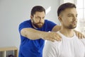 Young man on prevention examination an osteopath professional doctor in modern hospital office.