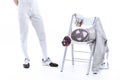 Young man professional fencer standing near chair with fencing equipment