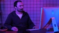 Young man programmer or hacker working on computer at night. Royalty Free Stock Photo