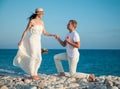 Young man proposing marriage to happy young woman Royalty Free Stock Photo