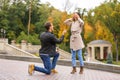 Young man proposing to his beloved in autumn park Royalty Free Stock Photo