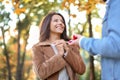 Young man proposing to his beloved in autumn park Royalty Free Stock Photo