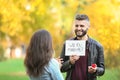 Young man proposing to his beloved in autumn park Royalty Free Stock Photo