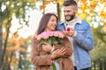 Young man proposing to his beloved in autumn park Royalty Free Stock Photo