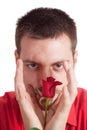 Young man protecting a red rose Royalty Free Stock Photo