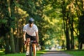 Young man in protective hemlet on a bike in the park Royalty Free Stock Photo