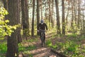 Young man in protective mask from environmental pollution riding mountain bike on cross country road. Cyclist Riding the Bike on Royalty Free Stock Photo