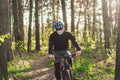 Young man in protective mask from environmental pollution riding mountain bike on cross country road. Cyclist Riding the Bike on Royalty Free Stock Photo