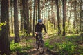 Young man in protective mask from environmental pollution riding mountain bike on cross country road. Cyclist Riding the Bike on Royalty Free Stock Photo