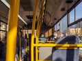 A young man in a protective mask and headphones sits on the bus