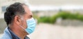 Young man in protective medical mask isolated against city background. Coronavirus advice. Safety men. Transmission of virus Royalty Free Stock Photo