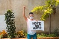 Young man at a protest holding a poster with free space for copies. Concept of protest