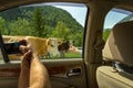 A young man pulling two hands into the open window Royalty Free Stock Photo