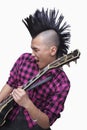 Young man with punk Mohawk playing guitar Royalty Free Stock Photo