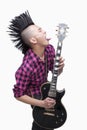 Young man with punk Mohawk playing guitar Royalty Free Stock Photo